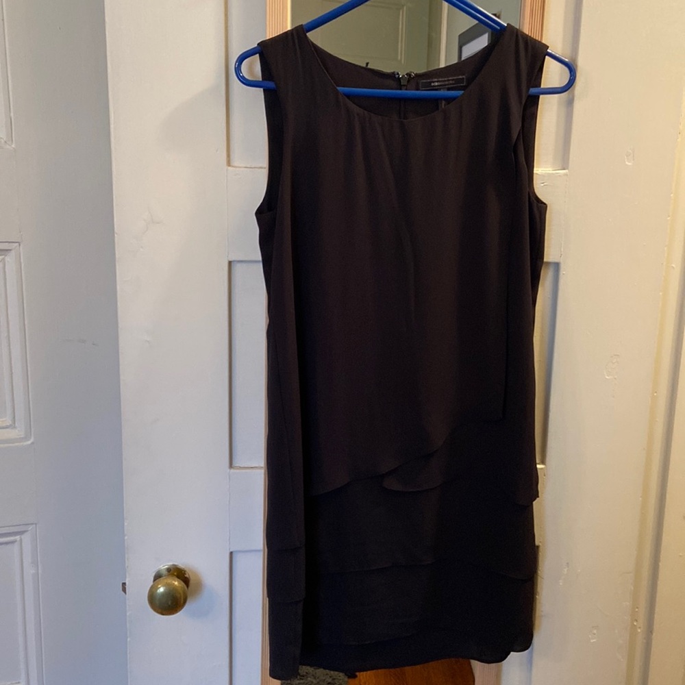 Simple black dress with asymmetrical detail